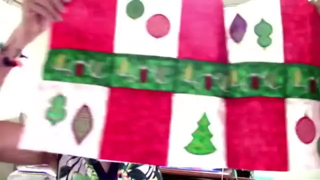 A Christmas table runner with metallic satin-stitched ornaments, showing the kind of shine and stitch definition you can get when metallic thread is set up correctly.