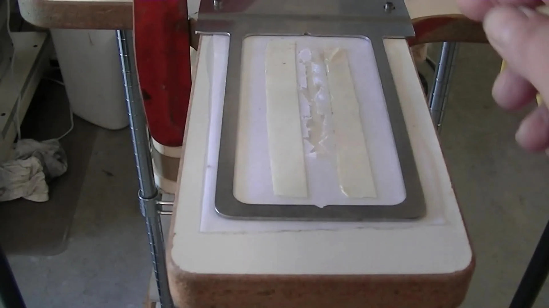 Close-up of alignment pins on a modified screen-printing pallet used as a jig to lock a Fast Frame in the same position every time.