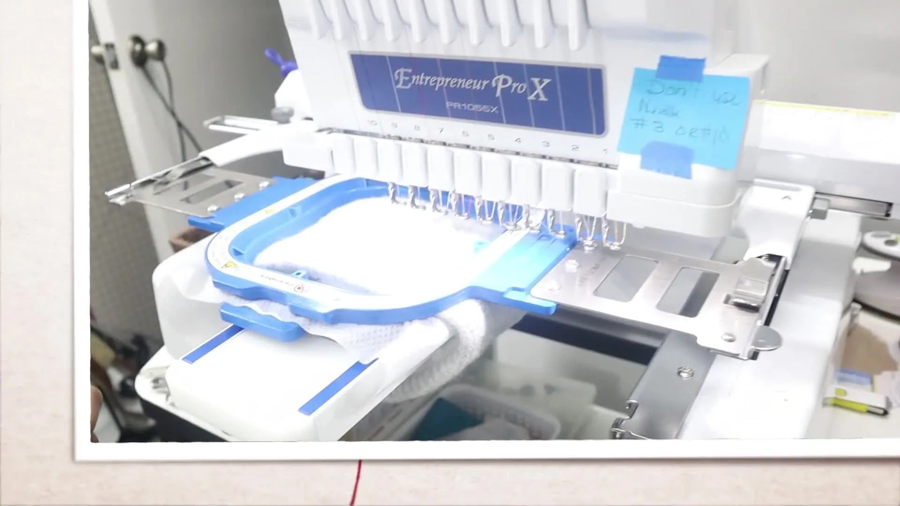 A close-up of the flattened knockdown stitch area on a textured knit headband inside a 5x5 magnetic hoop, ready for the final design stitching.