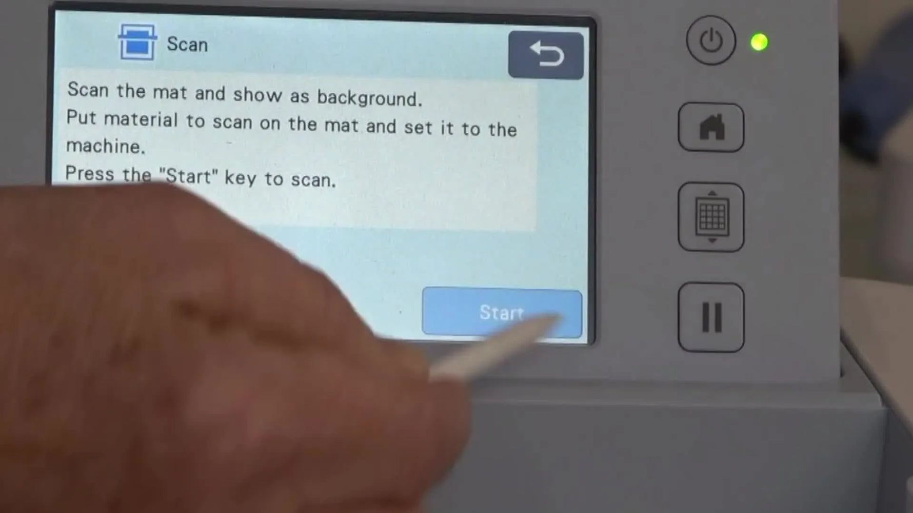 A close-up of the Brother ScanNCut SDX225 running a background scan on a fabric-loaded low tack mat so the cut lines can be aligned precisely.