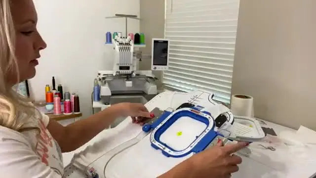 A close-up shows the magnetic top frame snapping down onto the tank top on the hooping station for fast, wrinkle-minimized clamping.