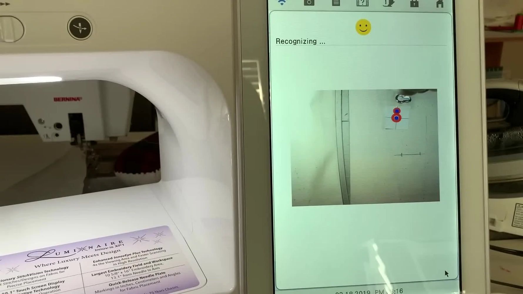 The Brother Luminaire screen shows the camera overlay recognizing the Snowman positioning sticker inside the hoop for precise alignment.