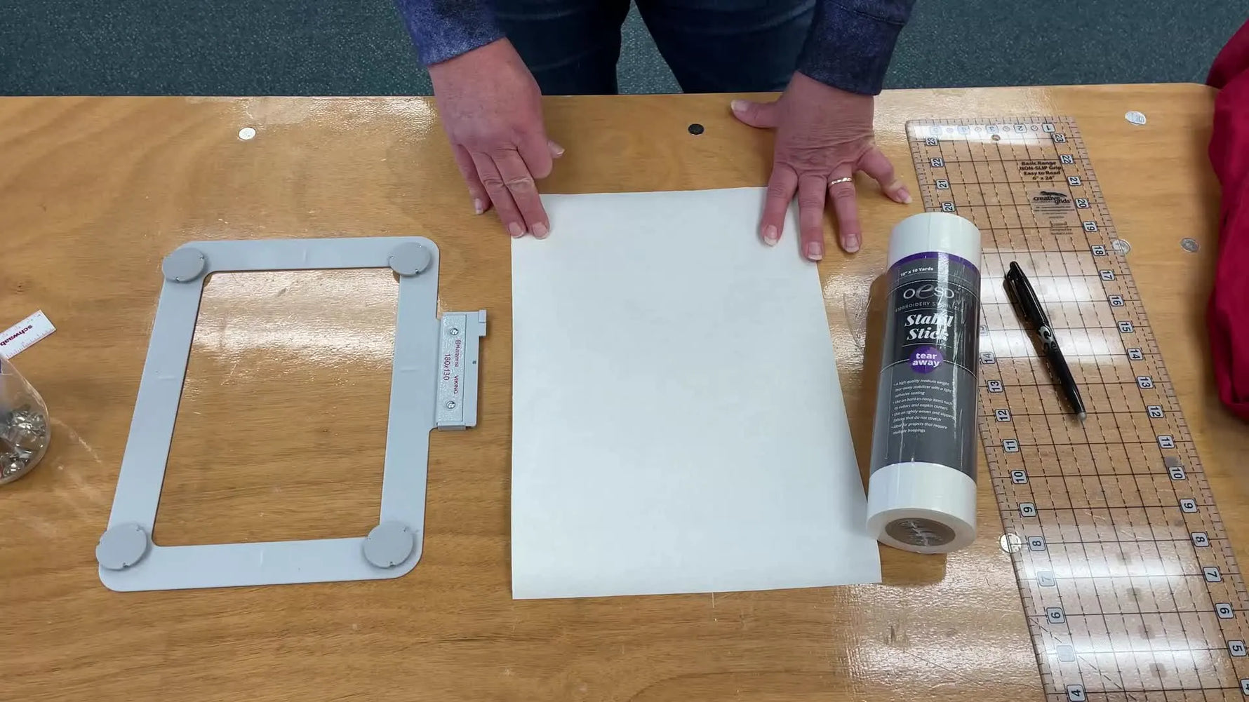 Overhead shot of a workspace with embroidery tools and materials.