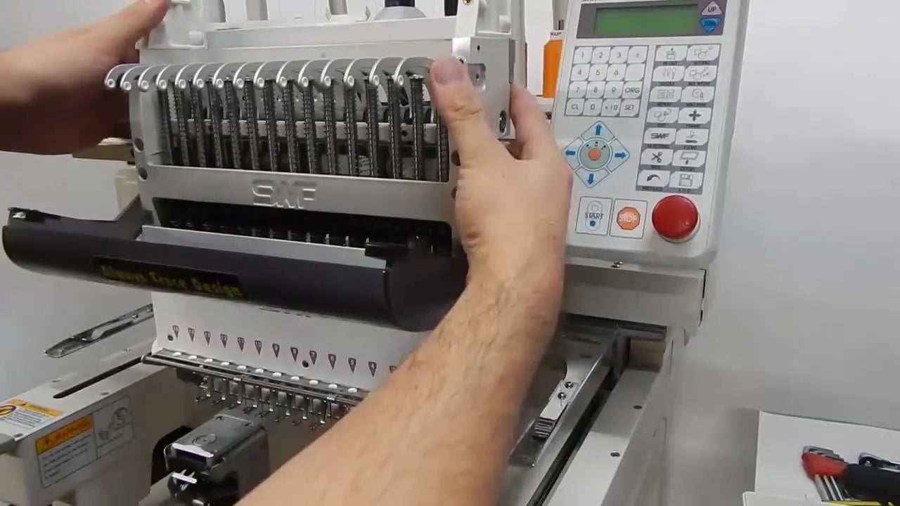 A technician lifts the SWF head up and forward to begin detaching it using the safe lift-and-unhook motion.