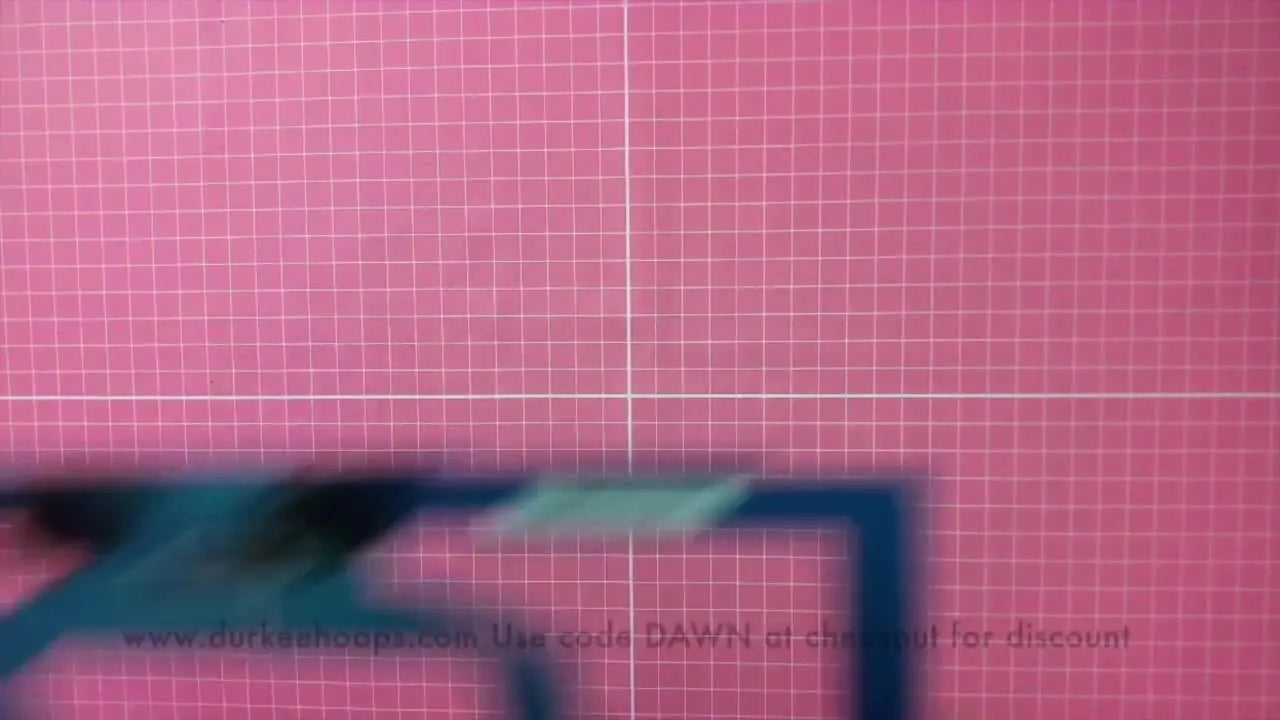 An overhead view of the Durkee Easy Cap Frame laid out off the machine, ready for cap hooping and setup.