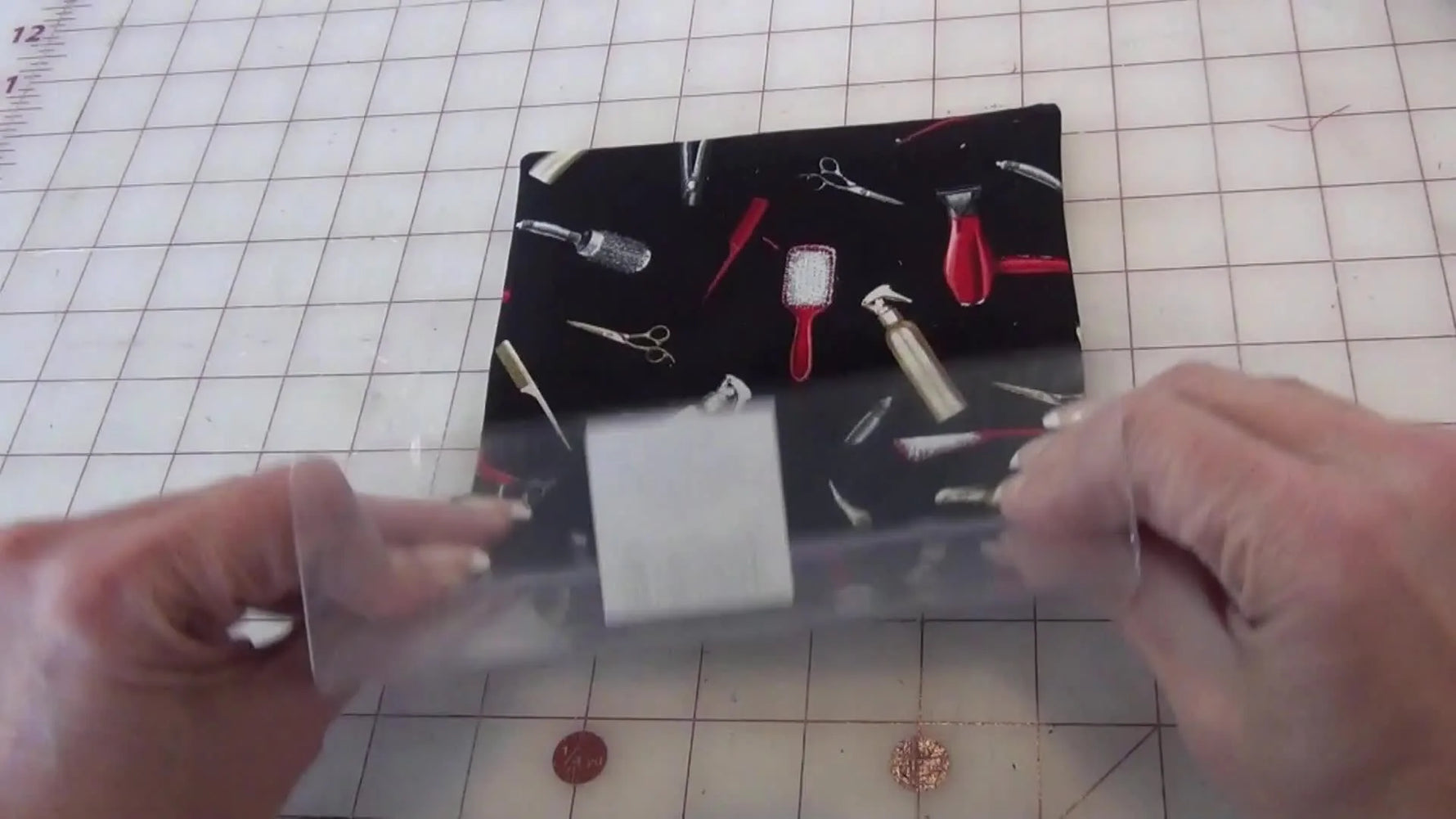 Inserting the clear acrylic frame into the tight fabric sleeve.