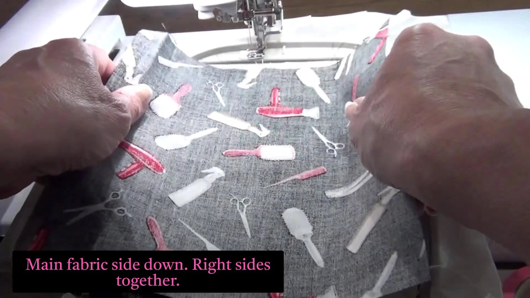 Placing the final backing fabric face down over the embroidery hoop before the final seam stitch.