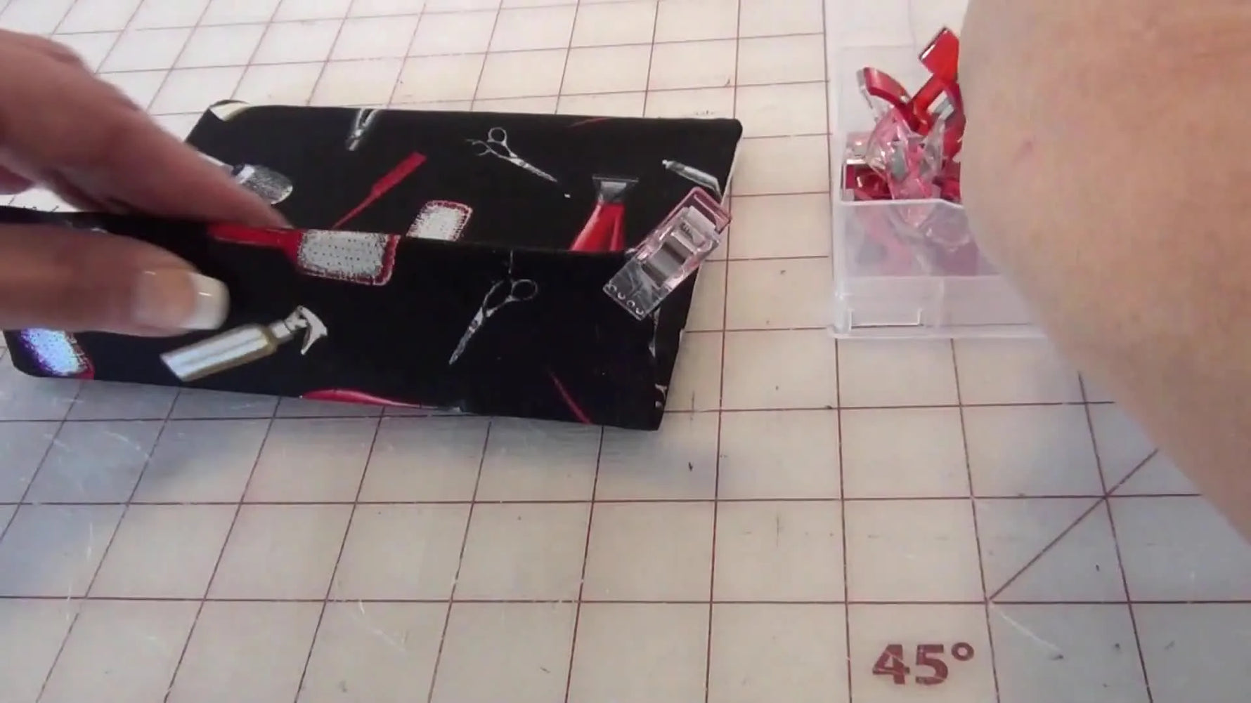 Red Wonder Clips clamping the glued fabric edge while it dries.